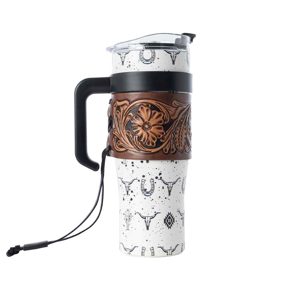 Myra Westmark and Bandana Tooled Western Tumblers in white and red stainless steel with hand-tooled leather wraps, combining heritage craftsmanship with modern utility.